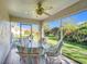 Relaxing screened porch with patio furniture and ceiling fan at 725 Beldon Ct, The Villages, FL 32162