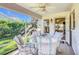 Relaxing screened porch with patio furniture and ceiling fan, offering a view of the backyard at 725 Beldon Ct, The Villages, FL 32162