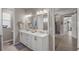 Elegant bathroom with double vanity and large mirror at 9307 Sw 104Th Ter, Ocala, FL 34481