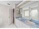 Bathroom with double vanity, light blue countertop, and access to another room at 11661 Sw 70Th Ct, Ocala, FL 34476