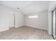 Bright bedroom with wood-look floors and a window with natural light at 11661 Sw 70Th Ct, Ocala, FL 34476