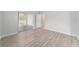 Spacious bedroom with wood-look floors and sliding glass doors to a patio at 11661 Sw 70Th Ct, Ocala, FL 34476