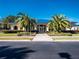 Community clubhouse with palm trees and a blue roof at 11661 Sw 70Th Ct, Ocala, FL 34476