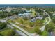 Aerial view of community, including homes, golf course, and pond at 11661 Sw 70Th Ct, Ocala, FL 34476