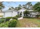 White house with gray accents, landscaping, and a two-car garage at 11661 Sw 70Th Ct, Ocala, FL 34476