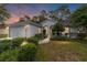 Inviting home exterior featuring a landscaped yard and attached garage at 11661 Sw 70Th Ct, Ocala, FL 34476