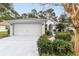 Front view of a single story home with a two-car garage at 11661 Sw 70Th Ct, Ocala, FL 34476