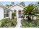 Well-maintained front entry with gray door and landscaping at 11661 Sw 70Th Ct, Ocala, FL 34476