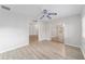 Bright living room with wood-look floors and ceiling fan at 11661 Sw 70Th Ct, Ocala, FL 34476