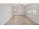 Living area with wood-look floors, ceiling fan, and sliding glass doors to a patio at 11661 Sw 70Th Ct, Ocala, FL 34476
