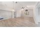 Bright living room with vaulted ceiling, wood-look floors, and large window at 11661 Sw 70Th Ct, Ocala, FL 34476
