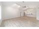 Open living room with vaulted ceiling, wood-look floors, and kitchen views at 11661 Sw 70Th Ct, Ocala, FL 34476