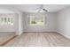Spacious living area featuring wood-look floors and a view to the backyard at 11661 Sw 70Th Ct, Ocala, FL 34476