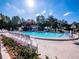 Community swimming pool with lounge chairs and a shaded area at 11661 Sw 70Th Ct, Ocala, FL 34476