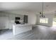 Modern kitchen with white shaker cabinets, quartz countertops, and a large island at 13024 Ne 6 Pl, Silver Springs, FL 34488