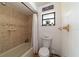 Updated bathroom with tub and shower combination, and neutral tile at 15330 Sw 59Th Ct, Ocala, FL 34473