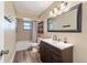 Updated bathroom with a vanity, tub, and tiled floors at 15330 Sw 59Th Ct, Ocala, FL 34473