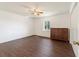 Simple bedroom with dark wood floors and a ceiling fan at 15330 Sw 59Th Ct, Ocala, FL 34473