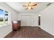 Bright bedroom with dark wood floors and a ceiling fan at 15330 Sw 59Th Ct, Ocala, FL 34473