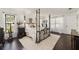 Spacious bedroom with dark wood floors, a large bed, and plenty of natural light at 15330 Sw 59Th Ct, Ocala, FL 34473