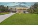 Ranch style home with gray exterior, attached garage, and well-manicured lawn at 15330 Sw 59Th Ct, Ocala, FL 34473