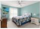 Light blue bedroom with a queen-size bed, dresser, and ceiling fan at 17757 Se 28Th Ln, Silver Springs, FL 34488