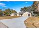 Front view of a single story home with a long driveway at 17757 Se 28Th Ln, Silver Springs, FL 34488