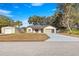 House exterior showcasing a two-car garage and a large yard at 17757 Se 28Th Ln, Silver Springs, FL 34488