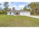 Newly built one-story house with gray siding, a white garage door, and a grassy yard at 22160 Sw Neptune Blvd, Dunnellon, FL 34431