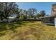 Large grassy backyard with screened enclosure at 24 Banyan Dr, Ocala, FL 34472