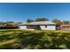 Back of house showcasing screened porch and large yard at 24 Banyan Dr, Ocala, FL 34472