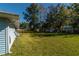 Large backyard with grassy area and mature trees at 24 Banyan Dr, Ocala, FL 34472