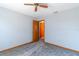 Bedroom with ceiling fan, grey carpet, and access to a bathroom at 24 Banyan Dr, Ocala, FL 34472