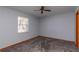 Bright bedroom with ceiling fan, grey carpet and a window at 24 Banyan Dr, Ocala, FL 34472