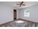 Spacious bedroom with ceiling fan, grey carpeting, and ample closet space at 24 Banyan Dr, Ocala, FL 34472