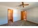 Bedroom with ceiling fan, grey carpet and multiple closets at 24 Banyan Dr, Ocala, FL 34472