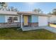 House exterior showcasing a yellow door and brick accents at 24 Banyan Dr, Ocala, FL 34472