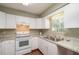 White kitchen with laminate countertops and stainless steel sink at 24 Banyan Dr, Ocala, FL 34472