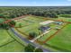 Aerial view showcasing a large property with equestrian facilities and a house at 3440 Ne 56Th St, Ocala, FL 34479