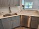 Modern kitchen featuring gray cabinets, quartz countertops, and stainless steel appliances at 3733 Se 137Th Street, Summerfield, FL 34491