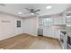 Updated kitchen featuring white cabinets, stainless steel appliances, and wood-look floors at 3931 Se 80Th St, Ocala, FL 34480