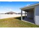 View of the home's exterior and backyard from the patio at 6071 Sw 93Rd Loop, Ocala, FL 34476