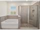 Modern bathroom with a soaking tub and a walk-in shower at 6071 Sw 93Rd Loop, Ocala, FL 34476