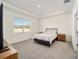 Spacious bedroom with carpeted floor and large window at 6071 Sw 93Rd Loop, Ocala, FL 34476