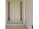 Light green front door with sidelights and a doorbell, ready to welcome you home at 6071 Sw 93Rd Loop, Ocala, FL 34476
