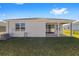 Rear view of house showing patio, yard, and AC unit at 6071 Sw 93Rd Loop, Ocala, FL 34476