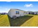 Side view of house showing patio and grassy yard at 6071 Sw 93Rd Loop, Ocala, FL 34476