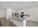 Modern kitchen with granite island and stainless steel appliances at 6071 Sw 93Rd Loop, Ocala, FL 34476