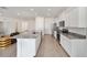 Modern kitchen with white cabinets, granite countertops, and stainless steel appliances at 6071 Sw 93Rd Loop, Ocala, FL 34476