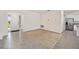 Open living room and kitchen area with beige rug, tiled floors, and neutral color scheme at 6071 Sw 93Rd Loop, Ocala, FL 34476